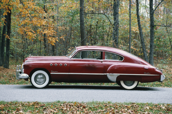 Classic car on autumn road