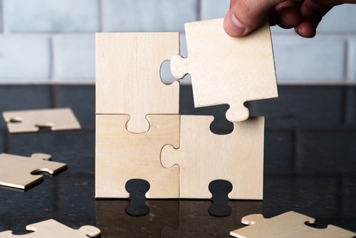 blank wooden puzzle pieces fitting together