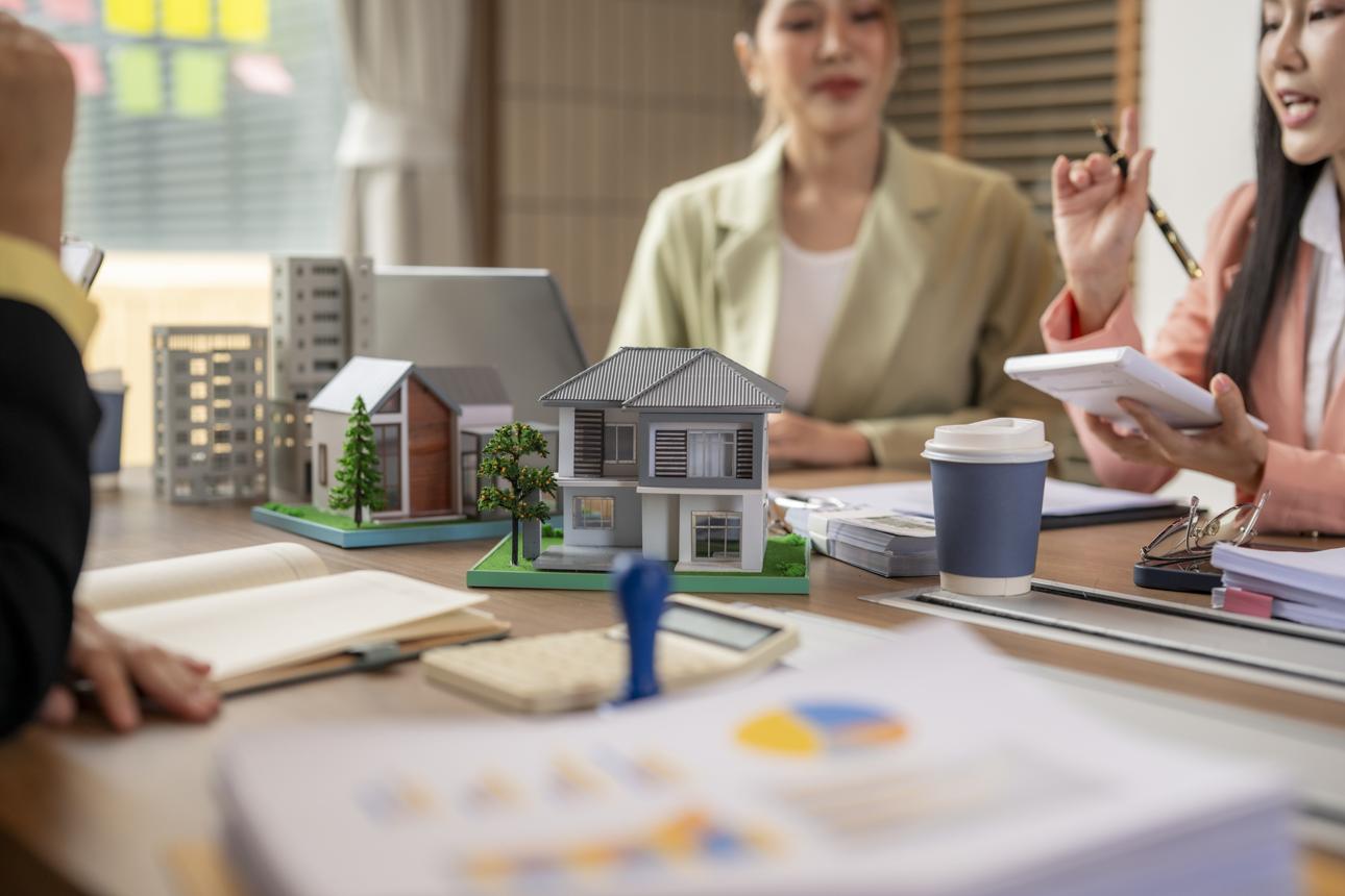 Real estate professionals discussing a home offer and negotiation strategy.