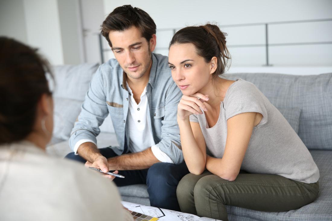 Homebuyers discussing concerns and decisions during the escrow process.