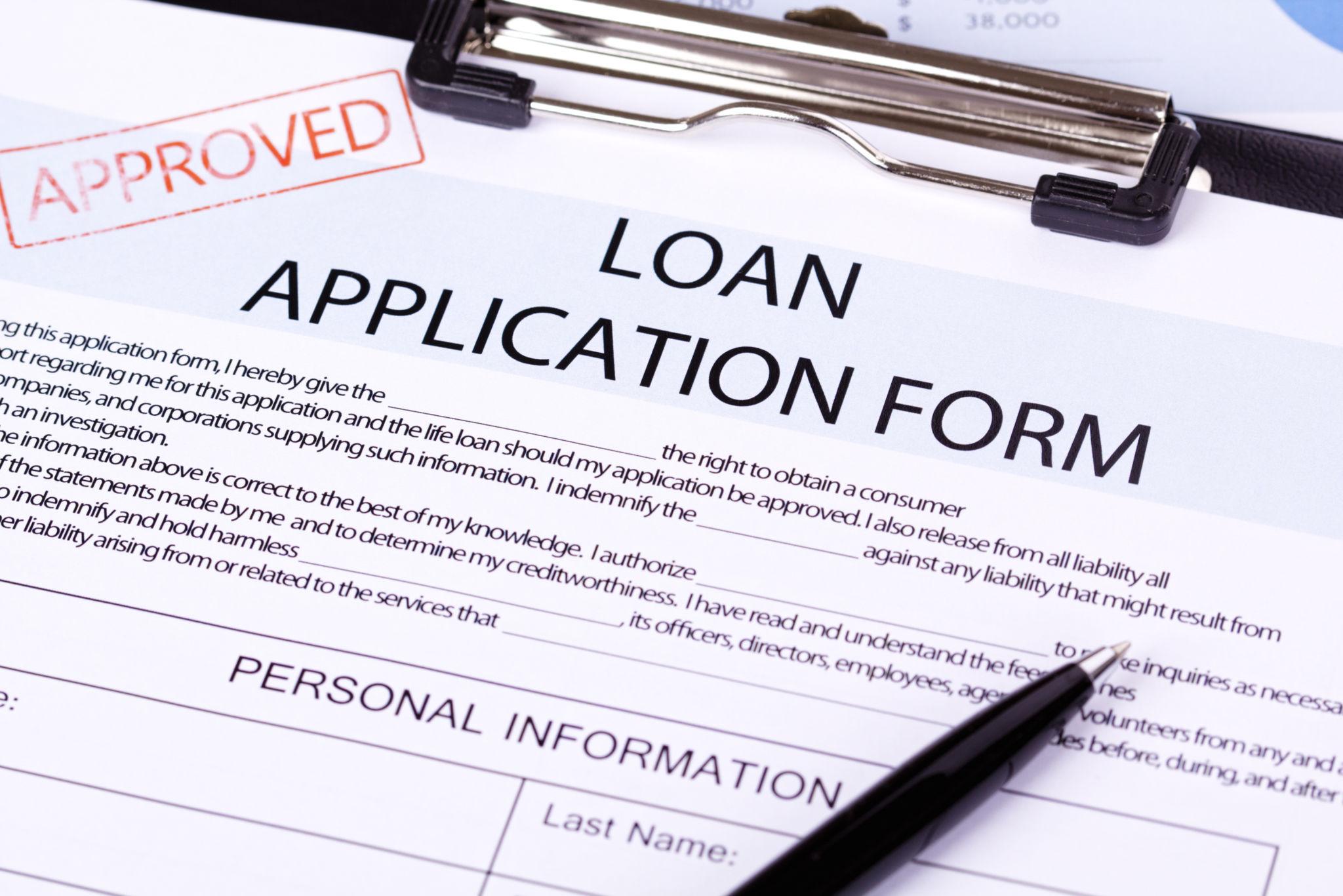 Homebuyer reviewing mortgage documents during the loan approval process.