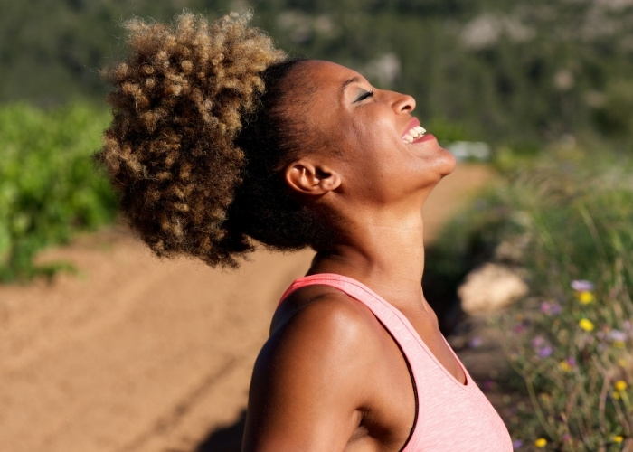 A Woman Taking a Holistic Approach to Health By Regulating Nervous System Outside in the Sun
