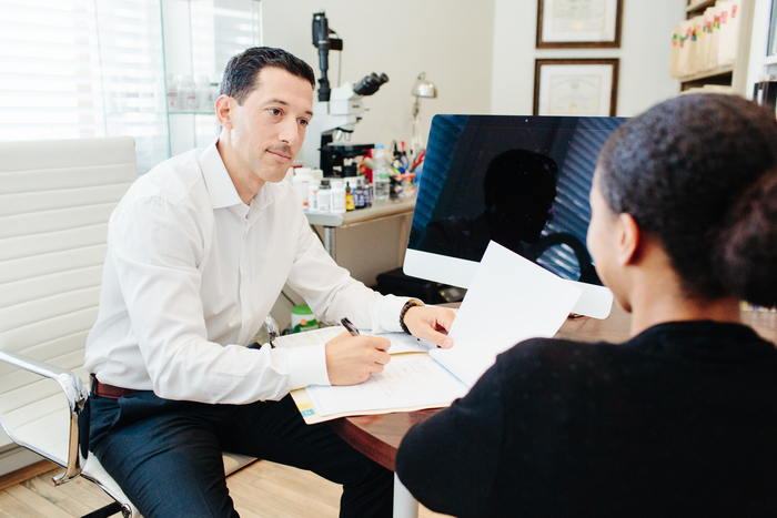 Dr. Cabral Working with Client