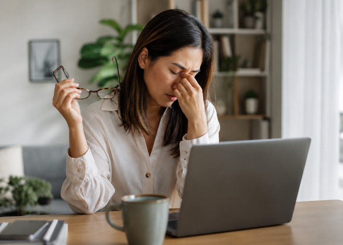 Stressed Out Woman with High Cortisol Working at Desk