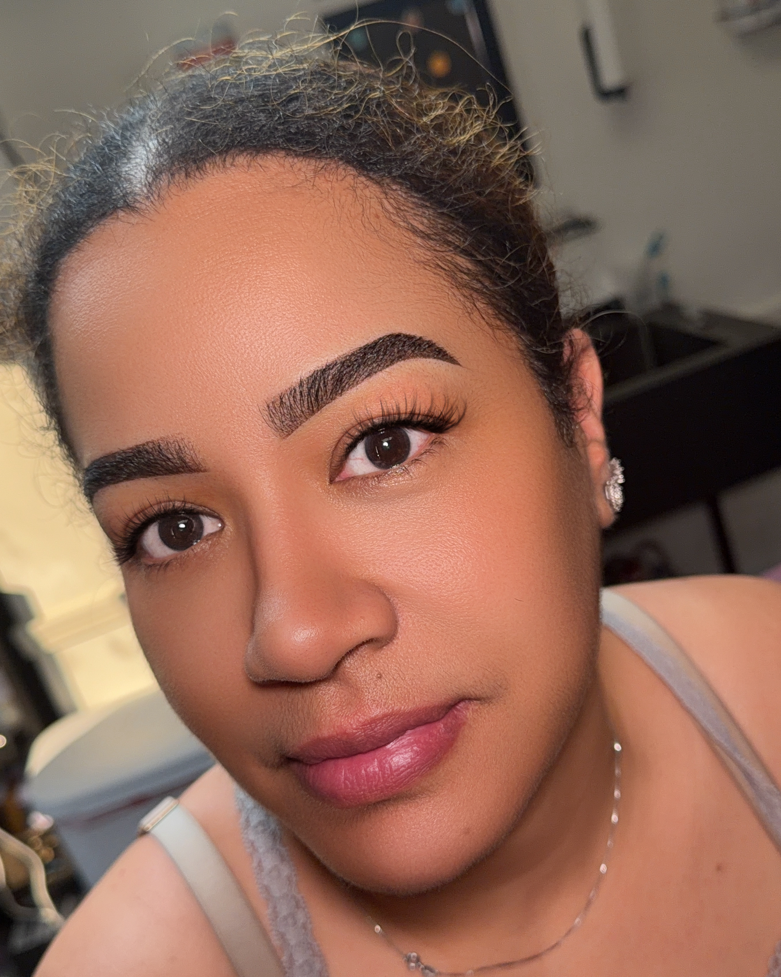 Angled client portrait showing freshly completed Ombré Powder Brows with defined arches and soft shaded fronts by Makeup By Mary LLC