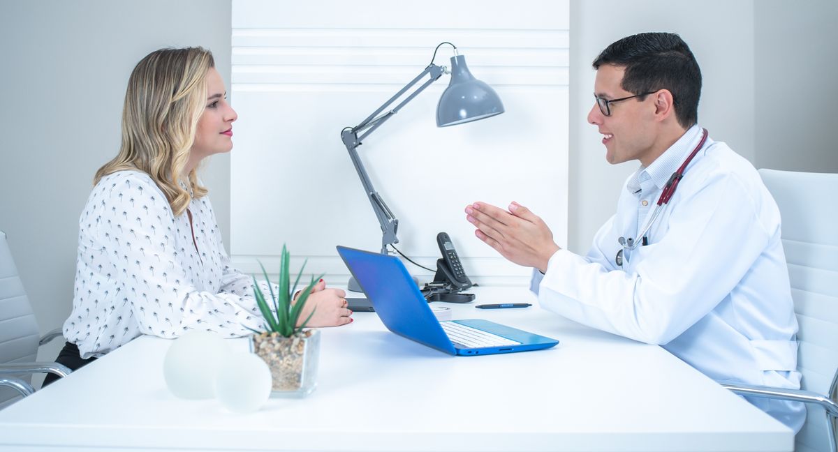 Woman talking with a doctor at a consultation