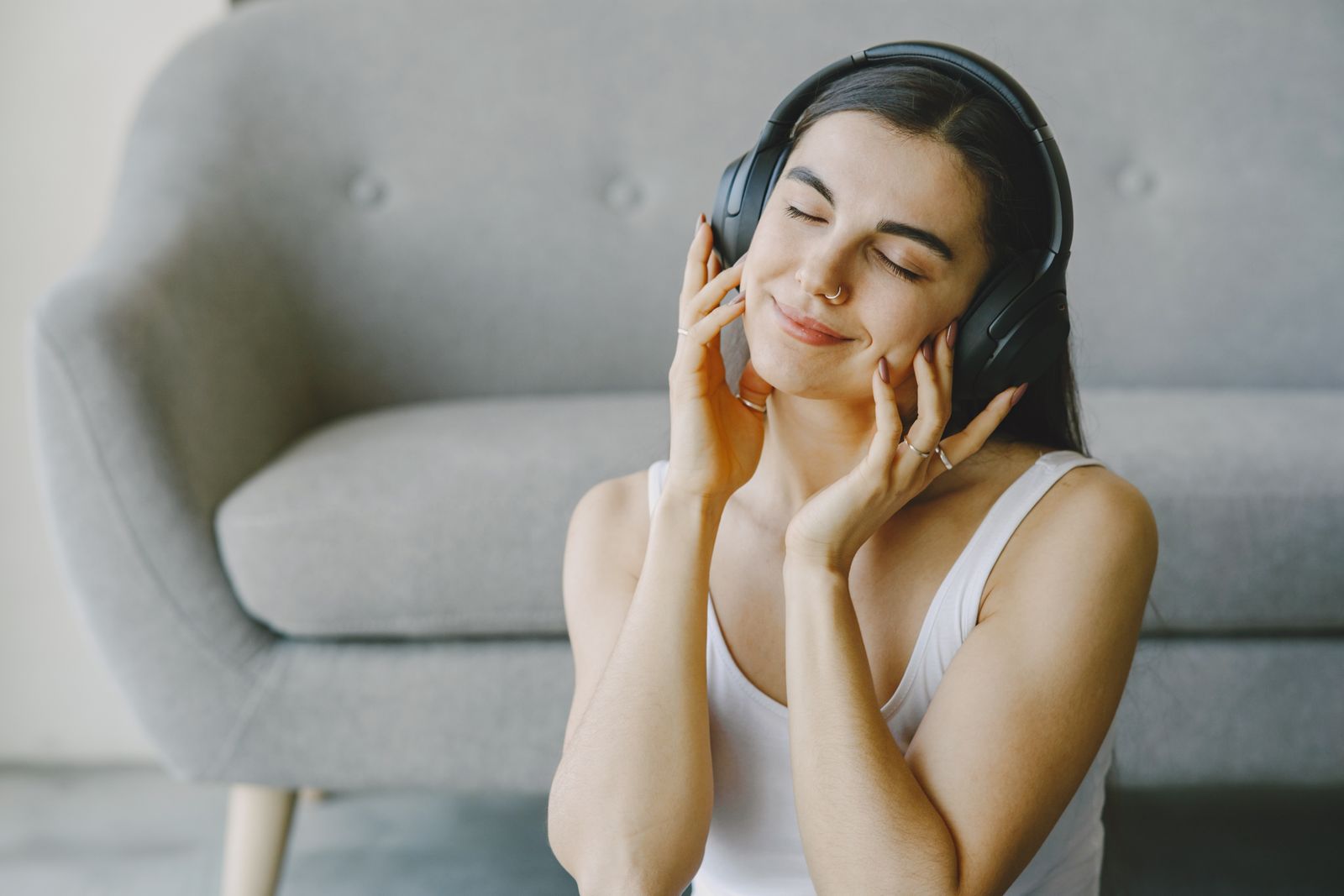 Woman relaxing with headphones and eyes closed