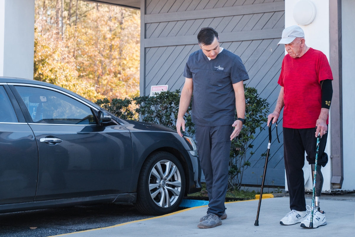 floyd brace clinician walking outside with elderly patient testing out new microprocessor prosthetic knee