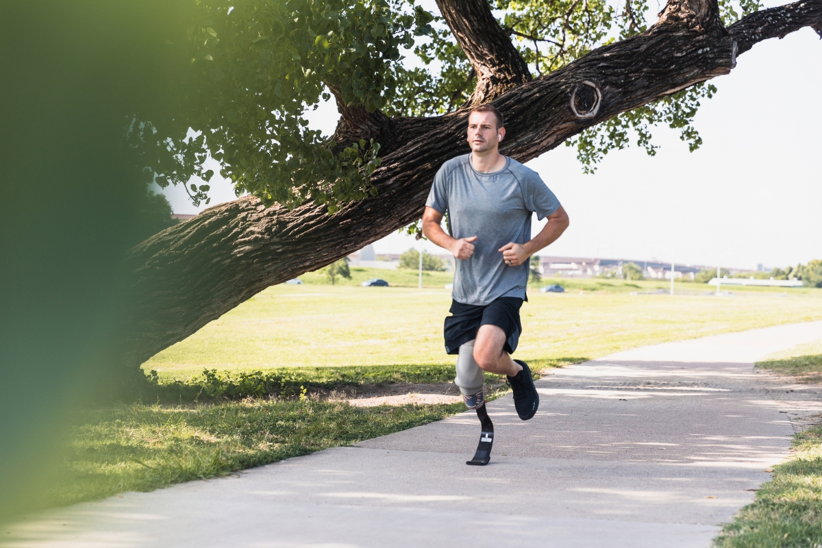 Person running outdoors with a specialized lower-limb prosthesis