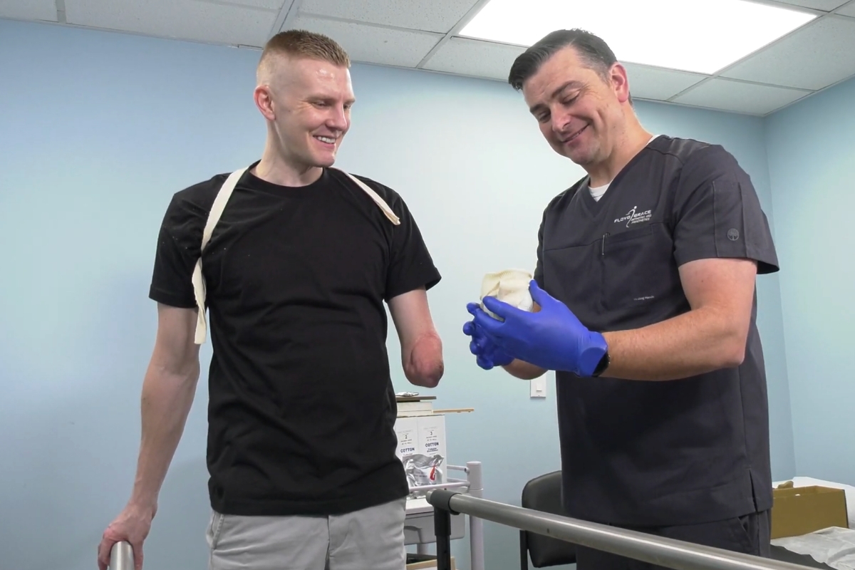 Prosthetist discussing a custom prosthetic component with a patient