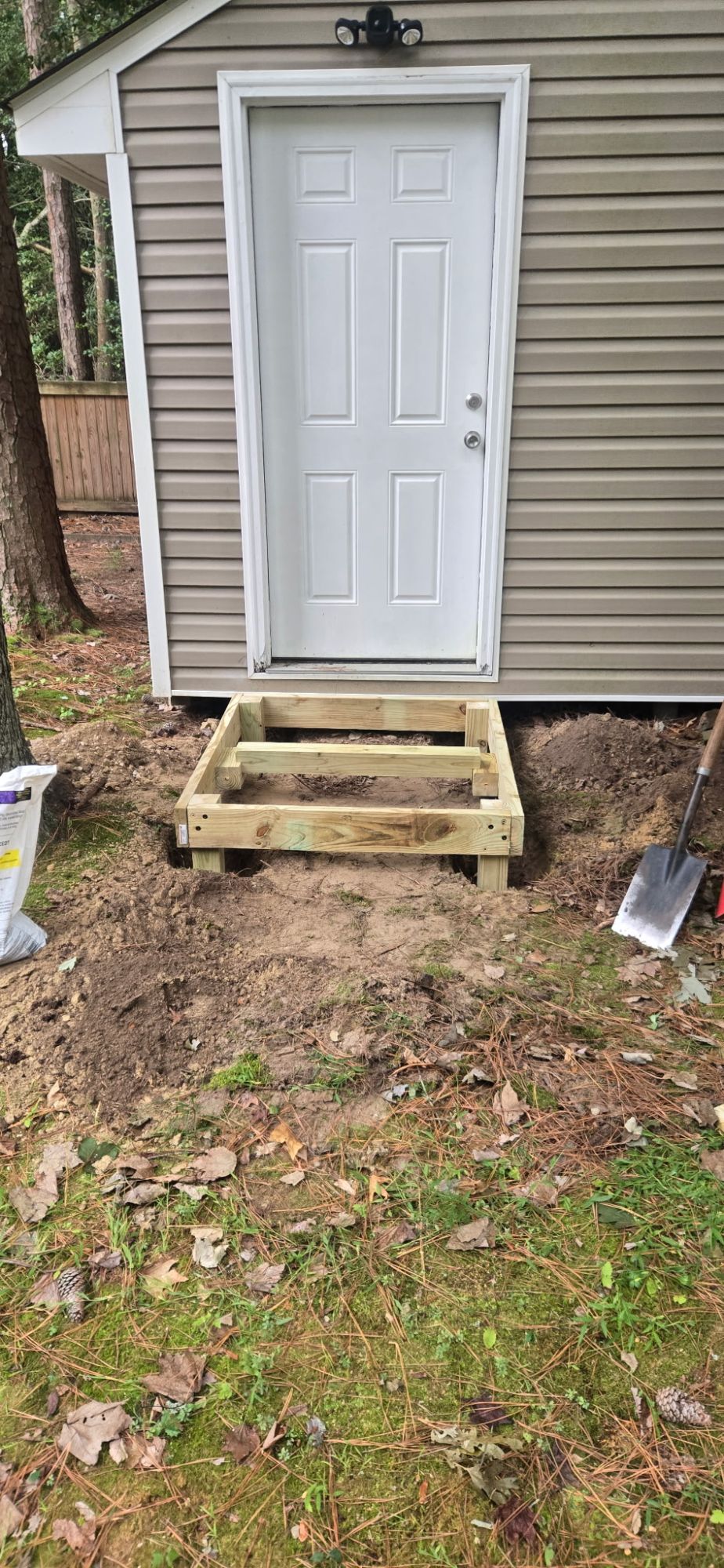 The frame set down into a dug-out pad at the shed door and levelled