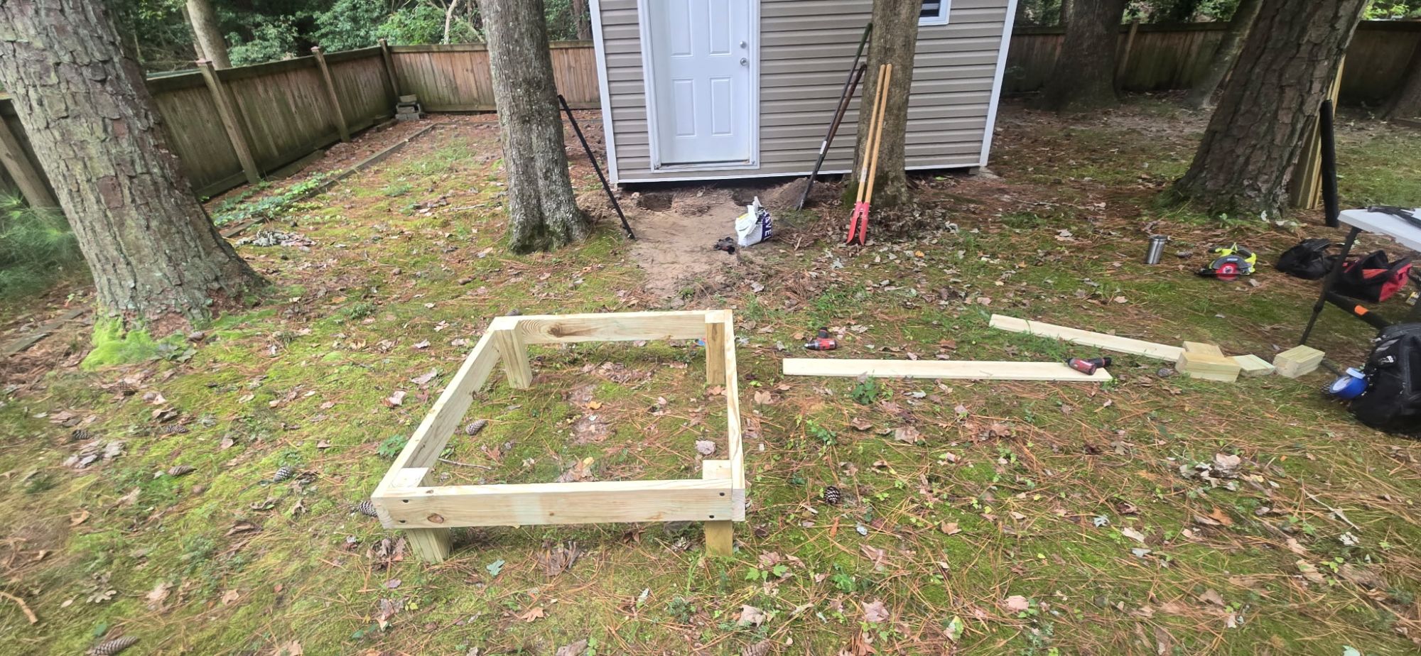 Pressure-treated frame for a shed step built on site, squared up on the grass