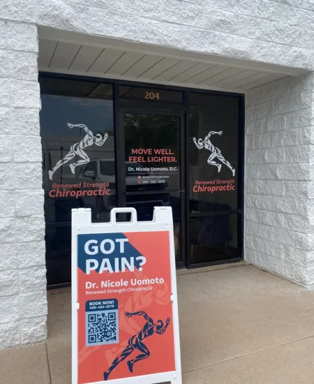 Entrance to Renewed Strength Chiropractic with window signage for Dr. Nicole Umamoto and a sidewalk sign reading “Got Pain?” outside the office. Entrance to Renewed Strength Chiropractic with window signage for Dr. Nicole Umamoto and a sidewalk sign reading “Got Pain?” outside the office.