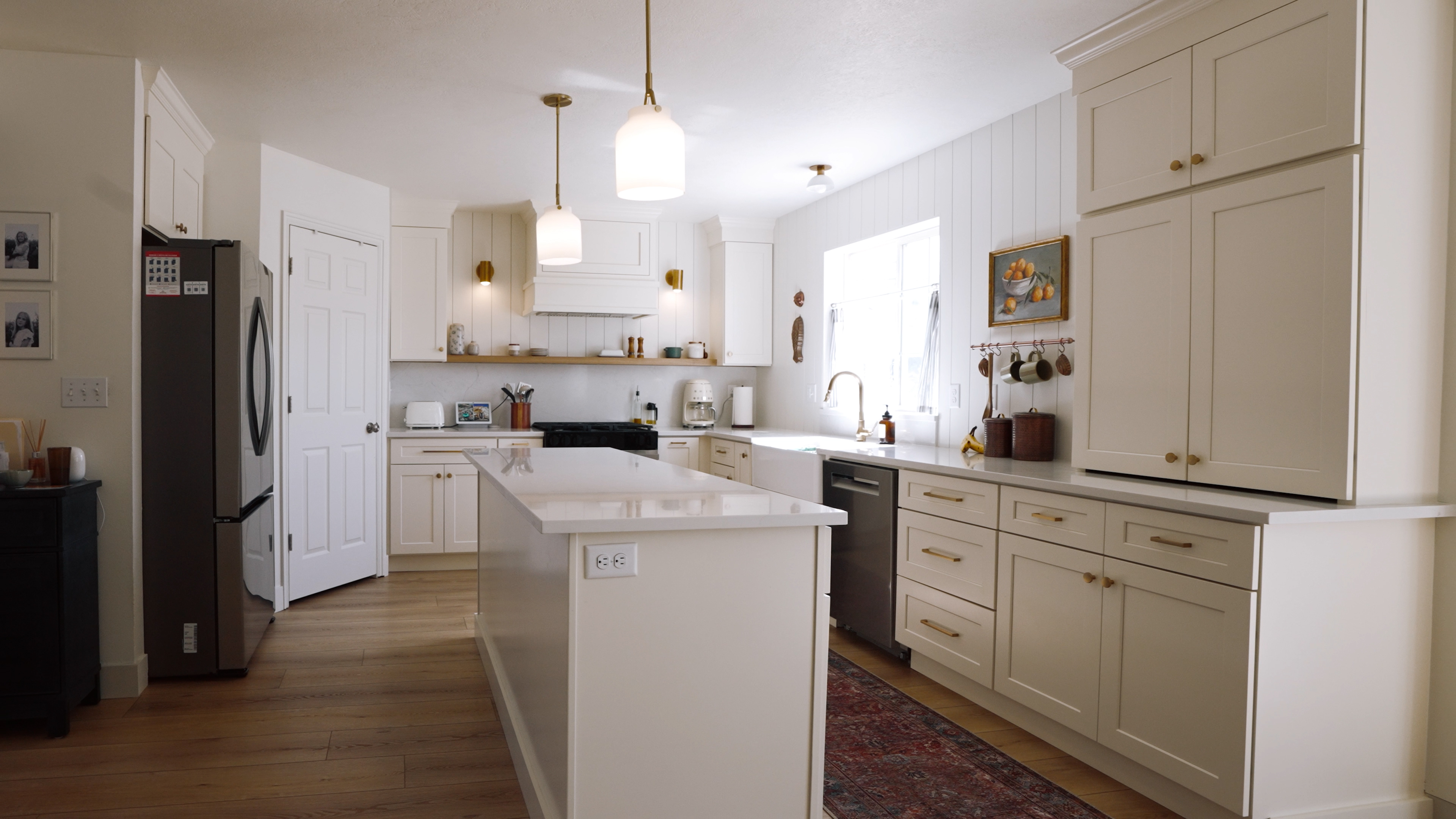 Completed custom kitchen remodel with painted shaker cabinets, quartz island, and brass hardware in the Salt Lake City area
