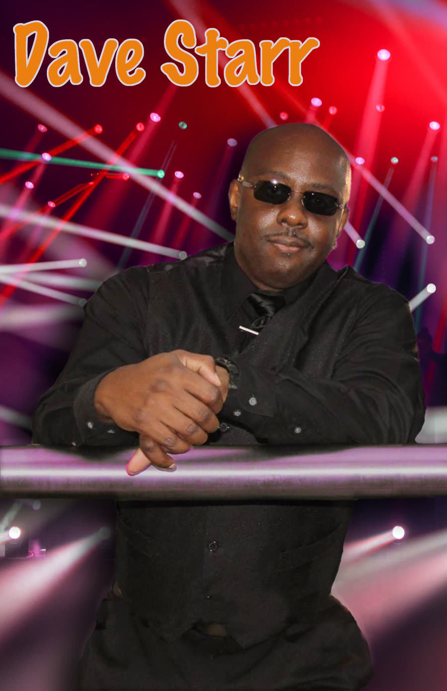 Dave Starr behind a drum kit under red and violet stage lighting.