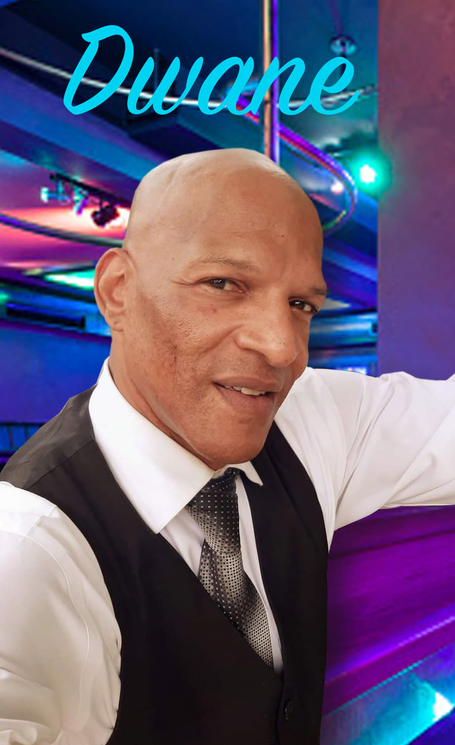 Dwane Abney in a waistcoat and tie under stage lights.