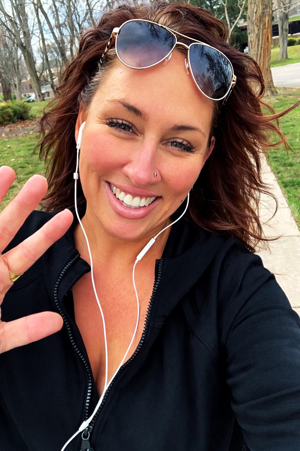 Woman walking outside in nature as part of a daily self-care routine
