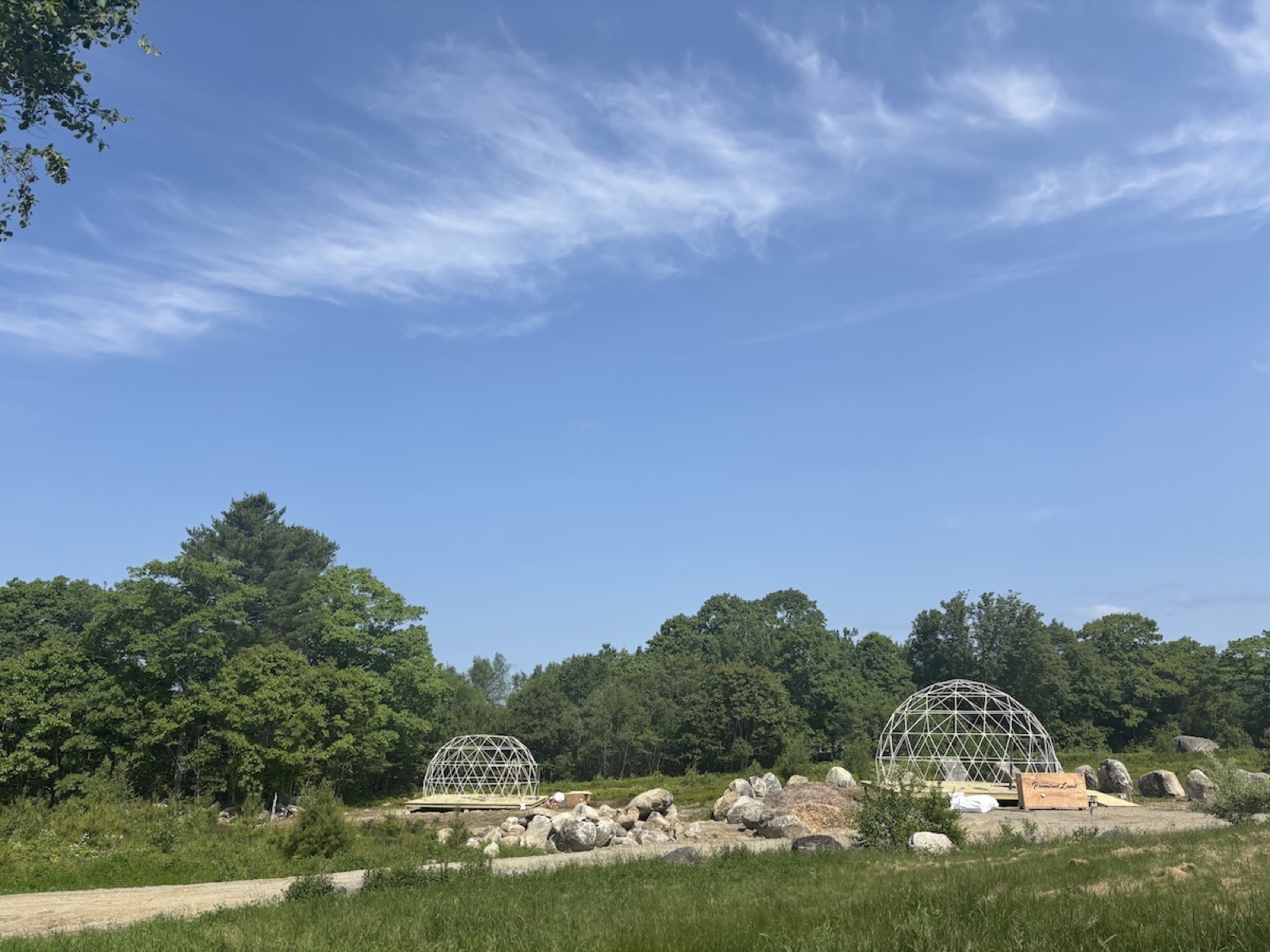 Cleared land with domes going up in the distance