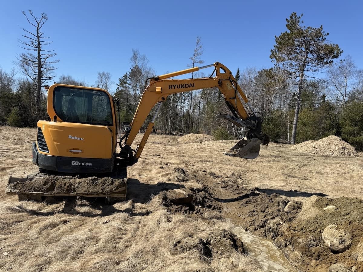 Excavator grading a raw building site