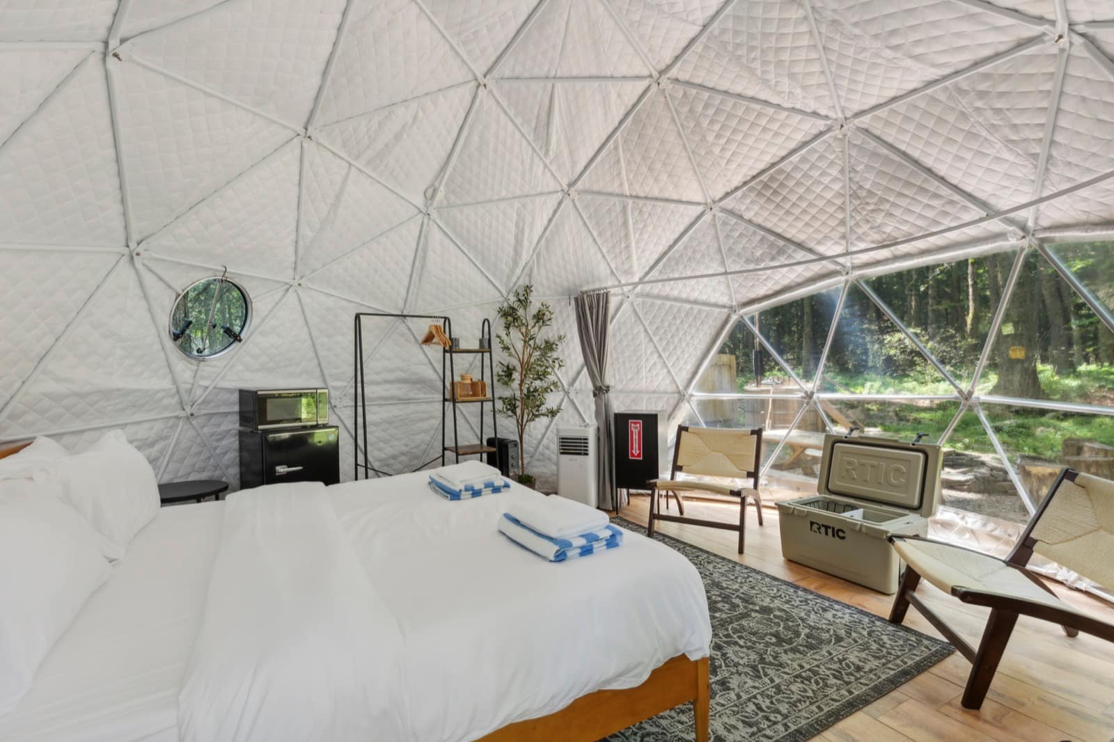 Furnished dome interior with a made bed