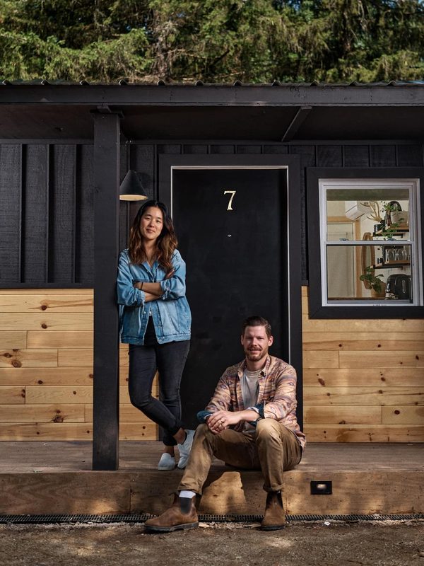 Brian Linton and co-founder on the porch of a renovated cabin
