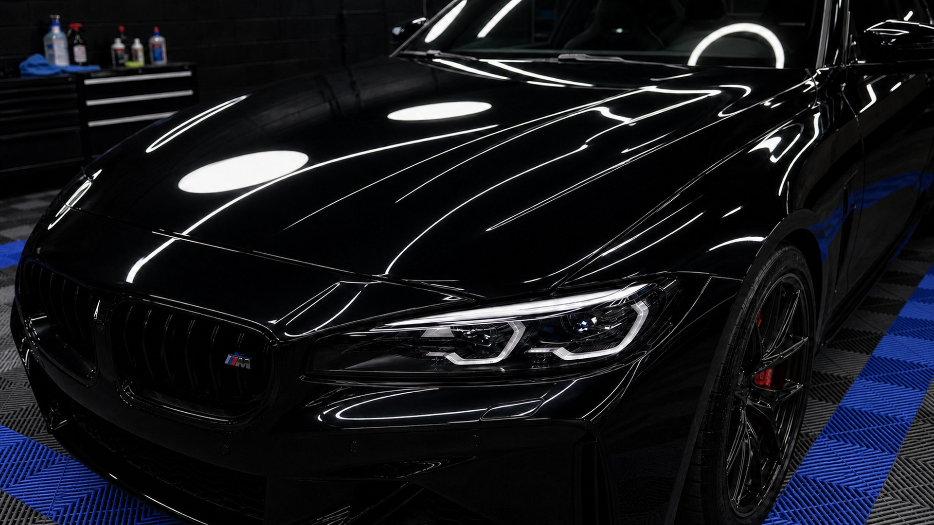 Flawless glossy black vehicle paint under inspection lighting