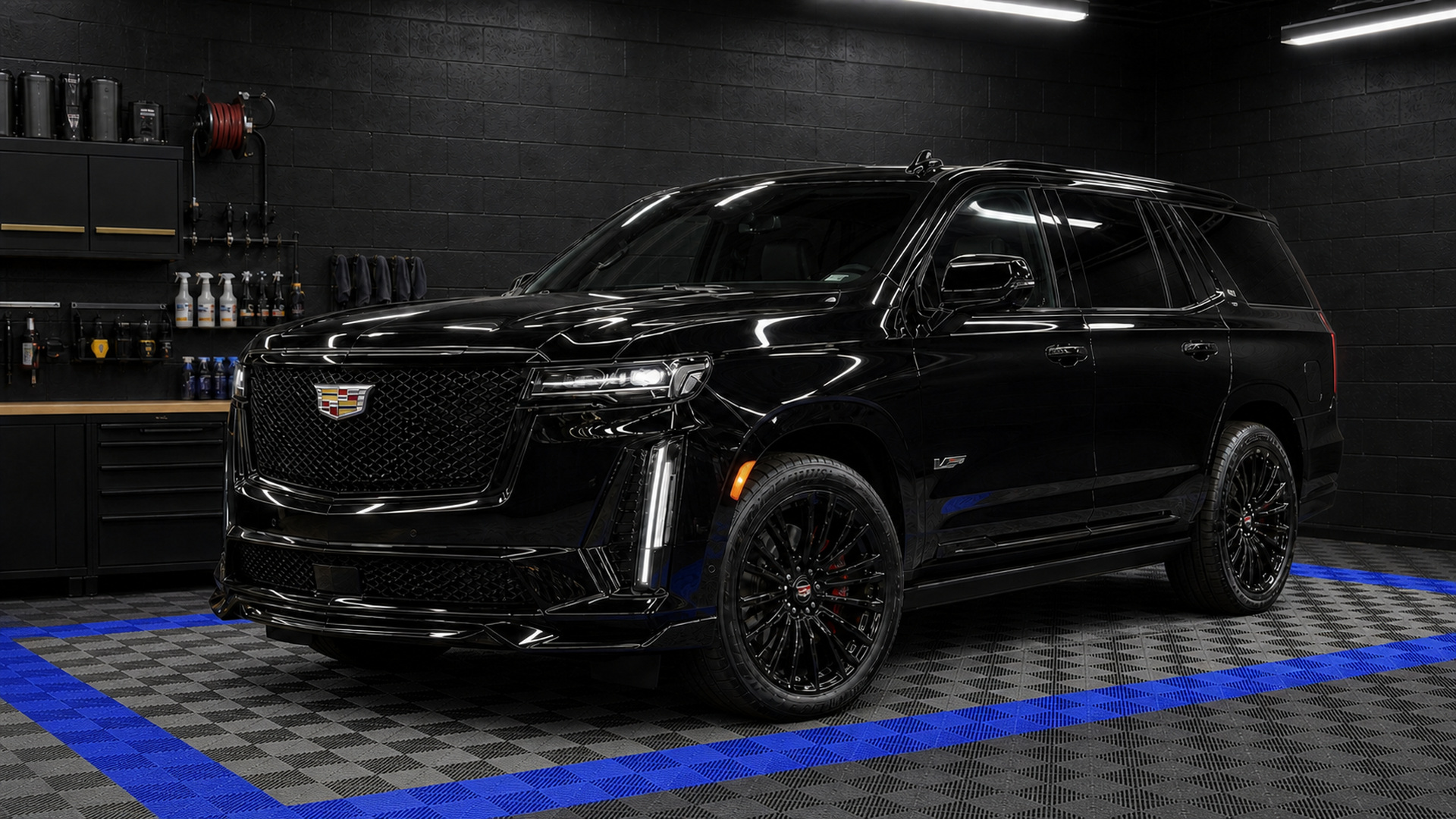 Black Cadillac Escalade-V beneath a long sequence of detailing inspection-light bays