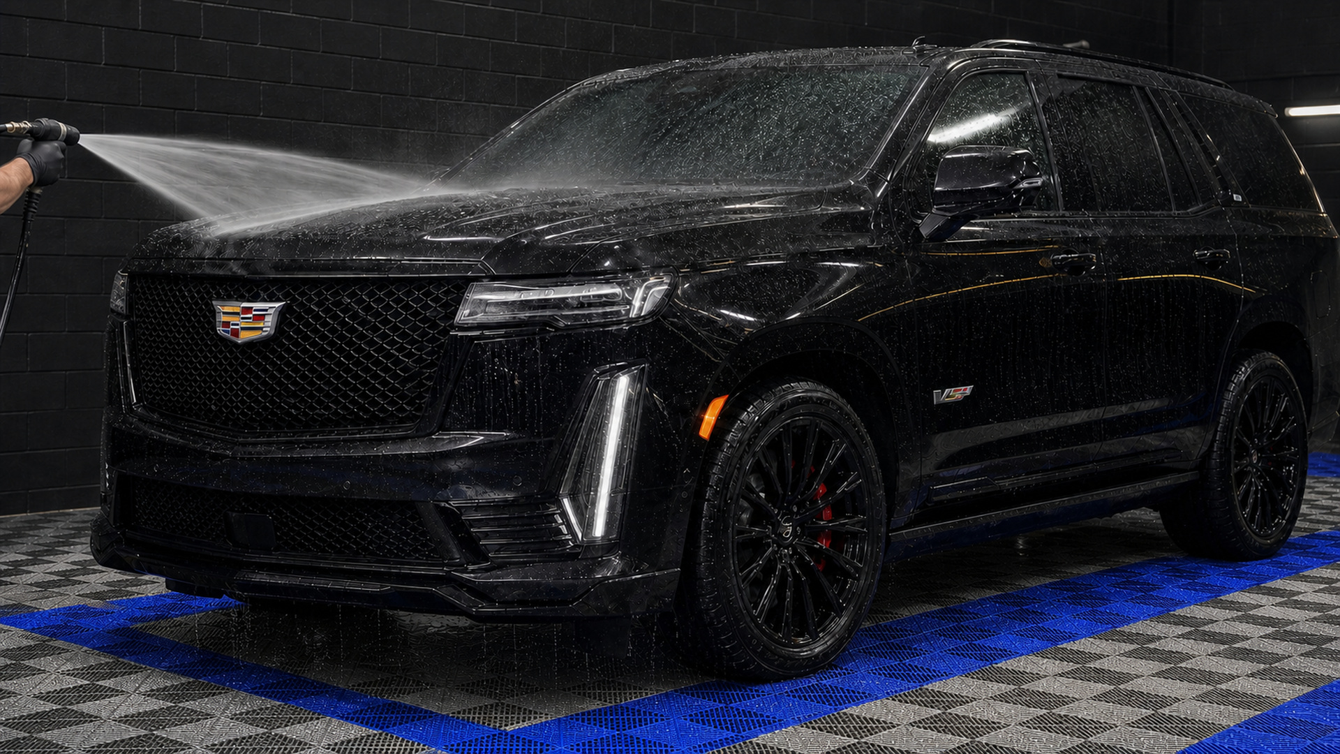 Black Cadillac Escalade-V receiving weekly exterior maintenance