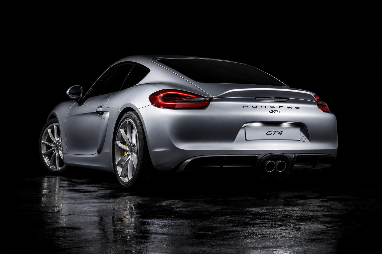 Porsche 981 Cayman GT4 — GT Silver Metalite, rear three-quarter studio photography
