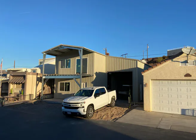 Residential steel workshop or garage with a roll-up door.