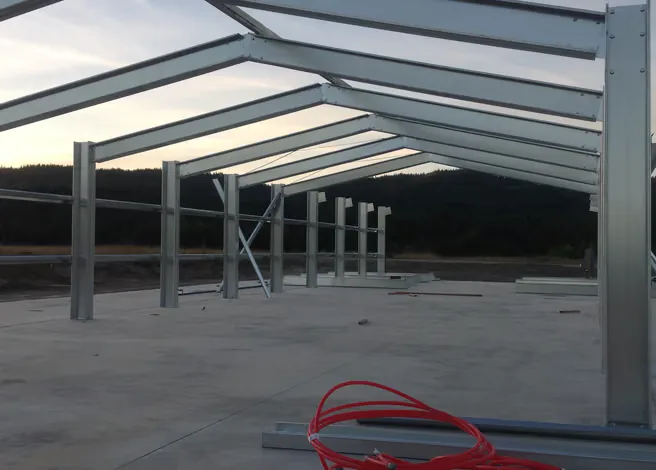 Industrial steel warehouse building with a long-span frame.