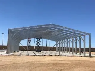 Industrial steel building with a wide interior span and high clearance.
