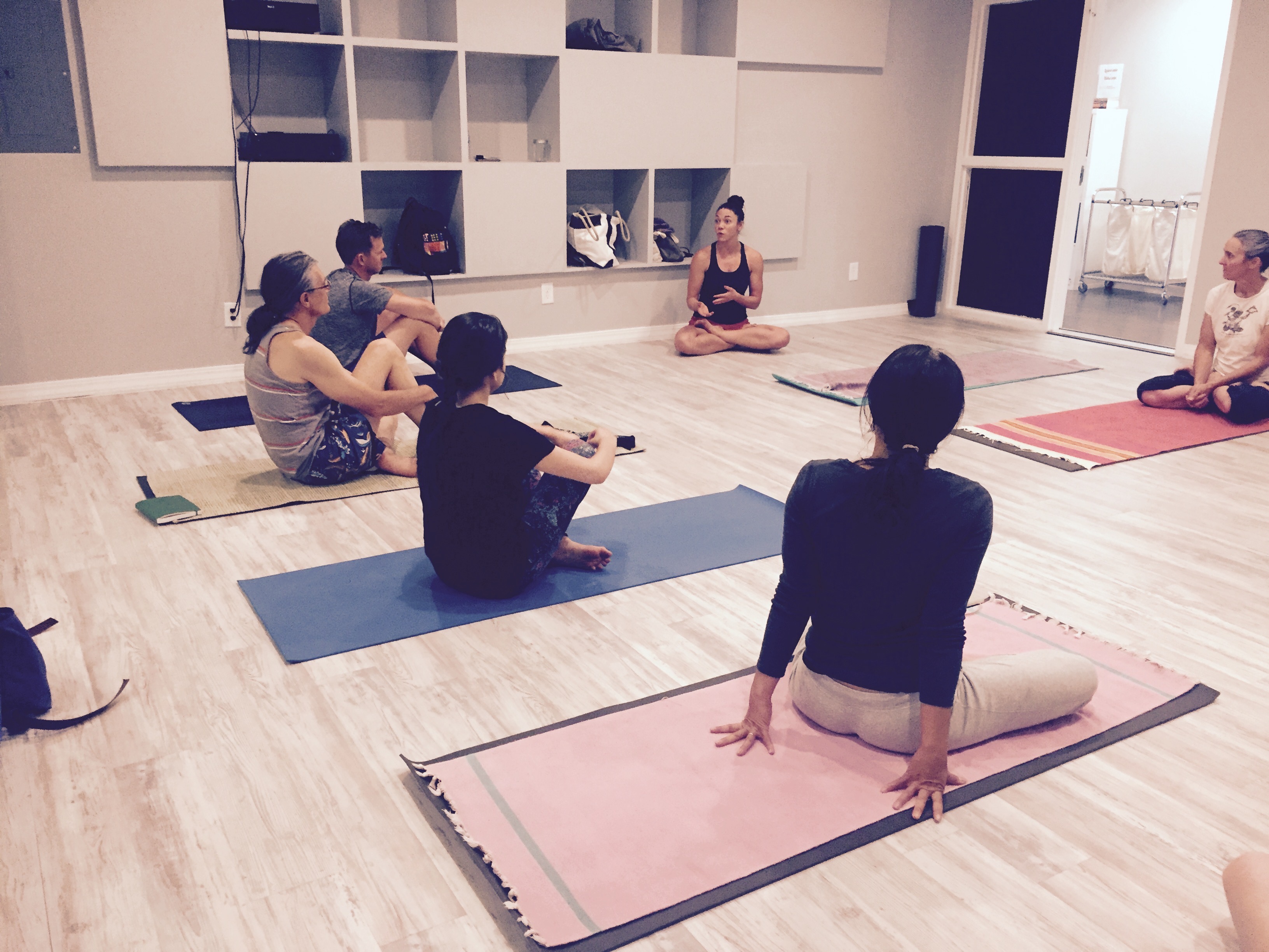 Yoga students sharing a meaningful community moment together