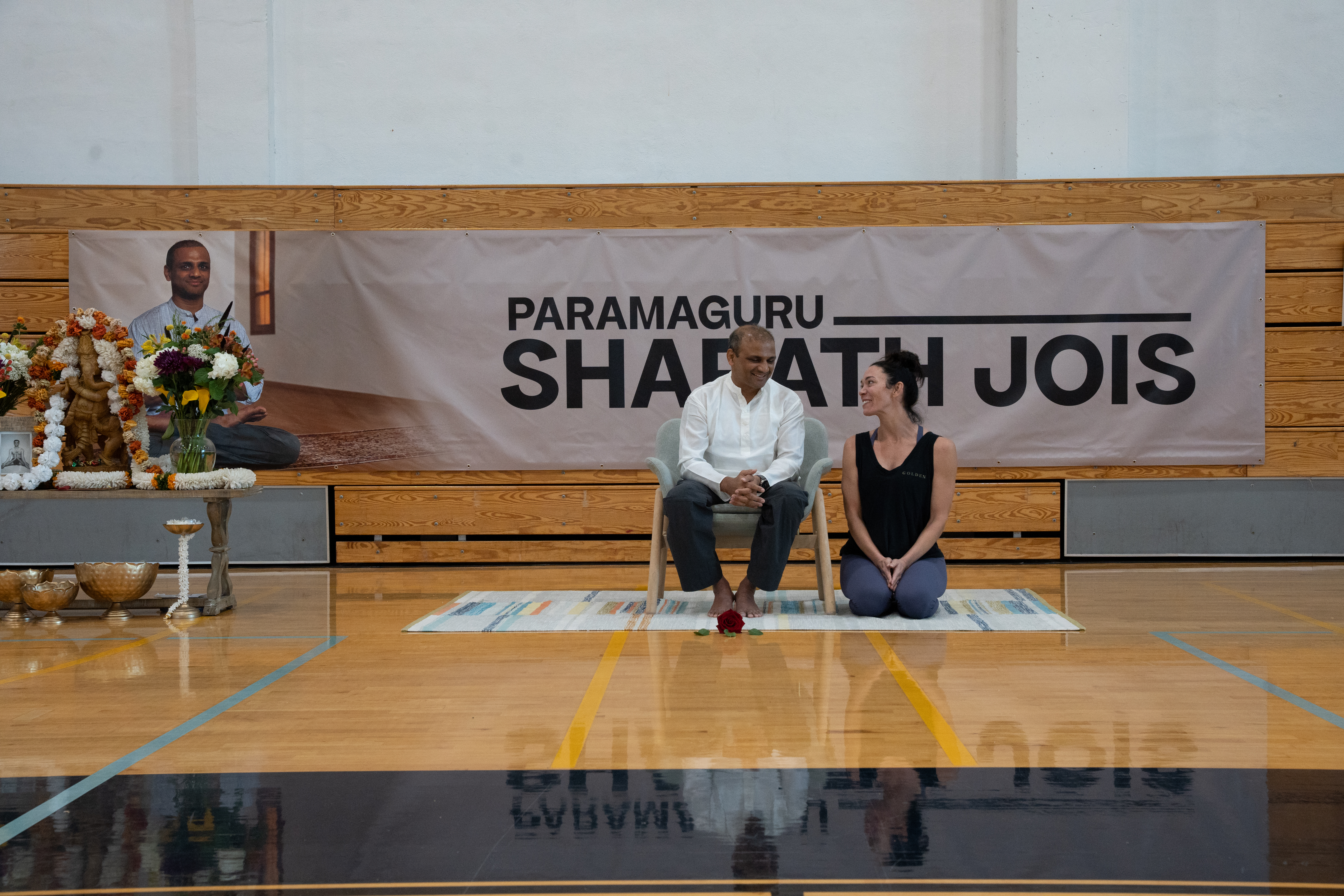 Teacher guiding a student during Ashtanga Yoga practice