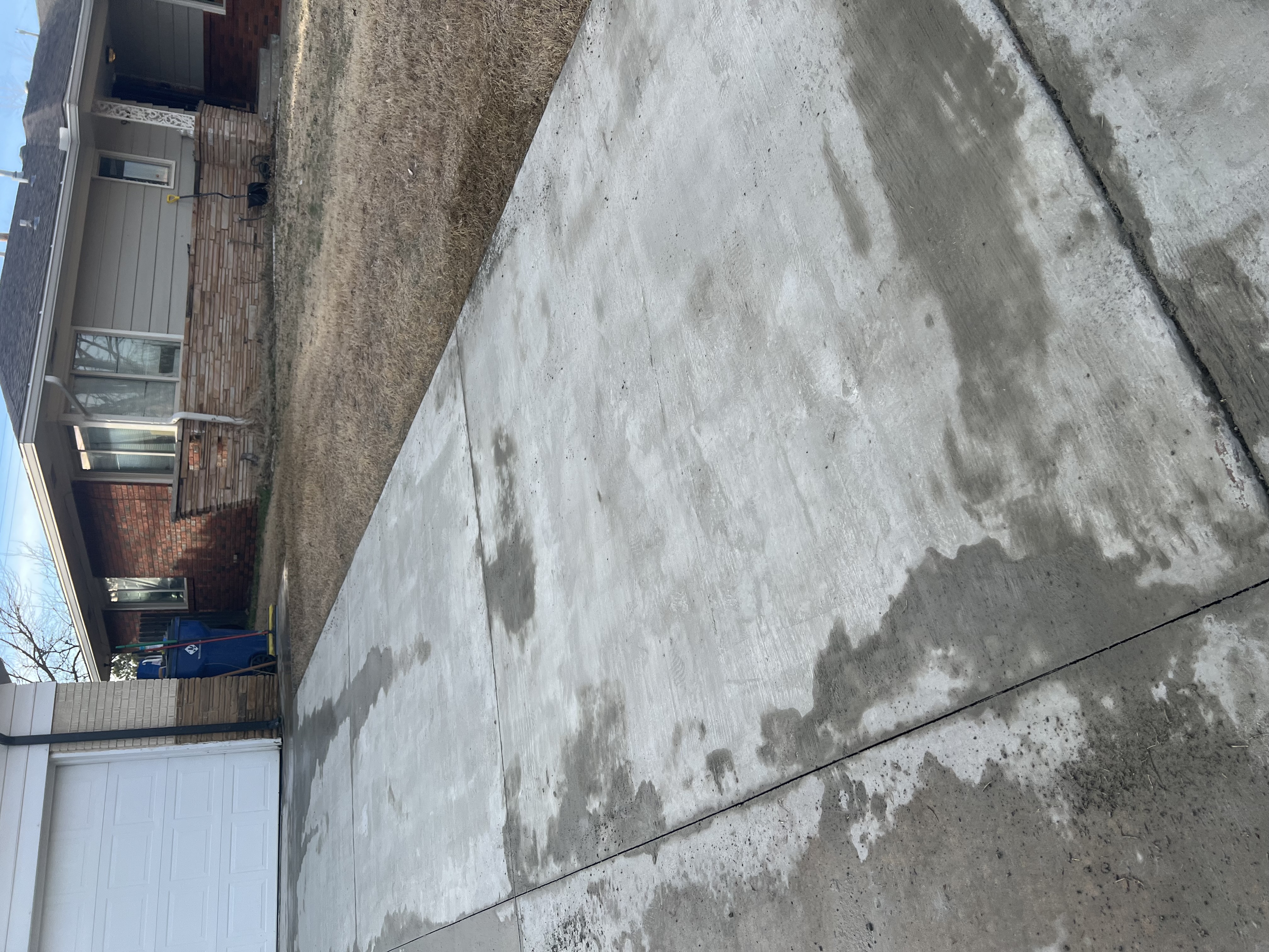 Fully resurfaced driveway with deep stains removed &mdash; Curb Elite Solutions