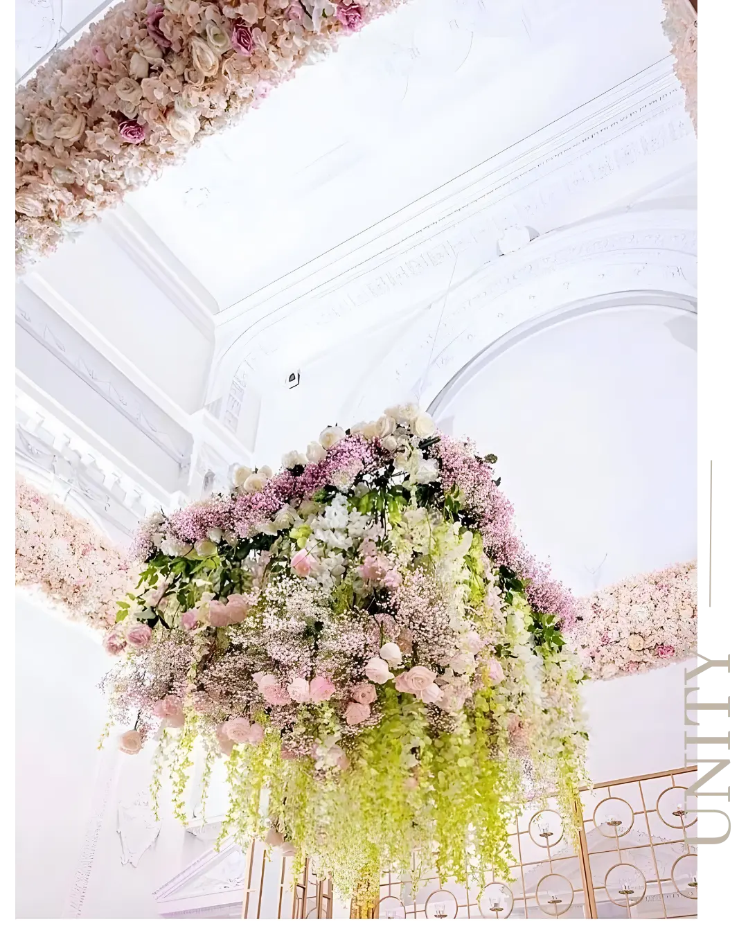 Hanging ceiling floral installation with soft pink and white flowers cascading above a wedding reception in Montreal