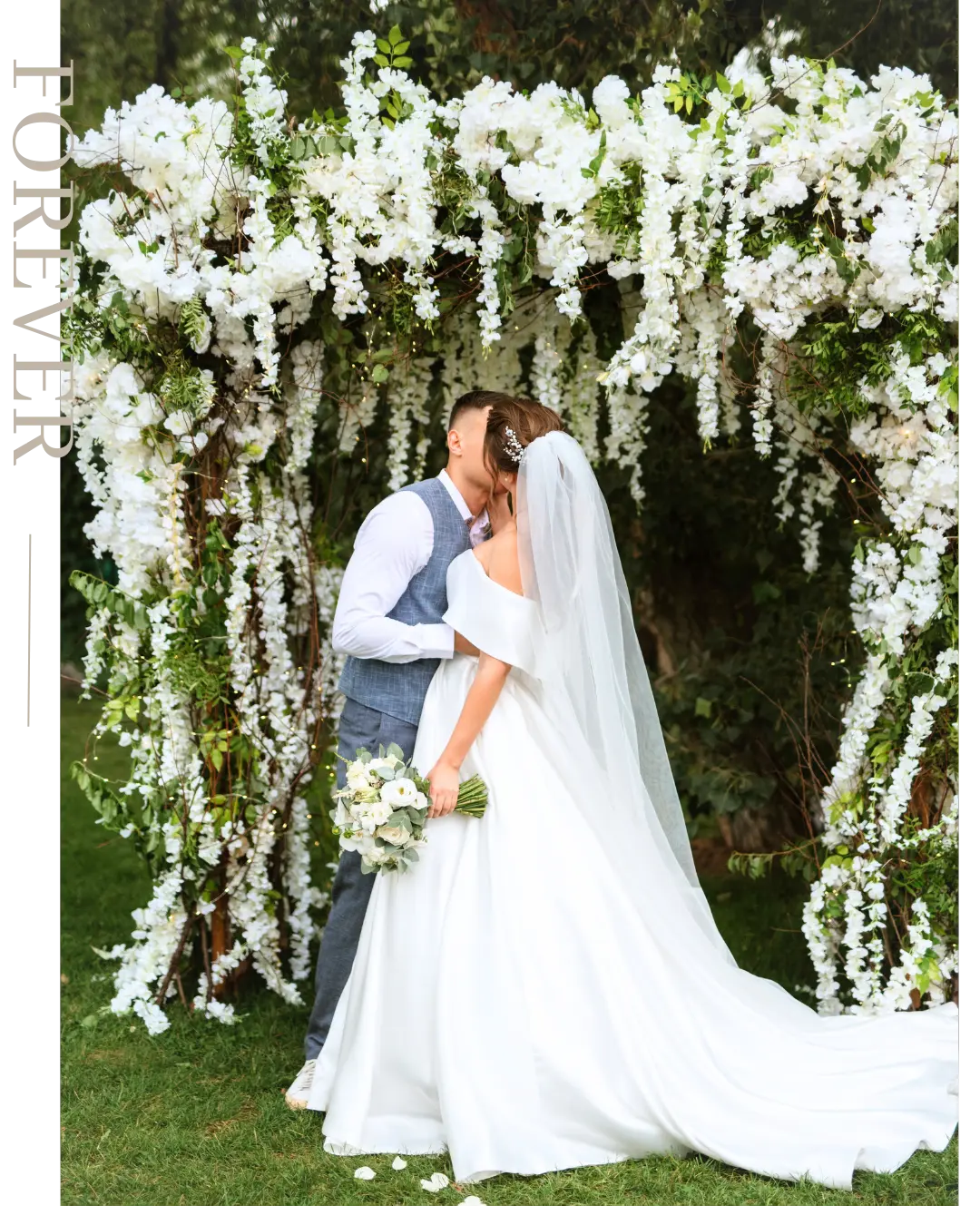 Bride and groom under an outdoor garden chuppah adorned with cascading white flowers during a romantic wedding ceremony