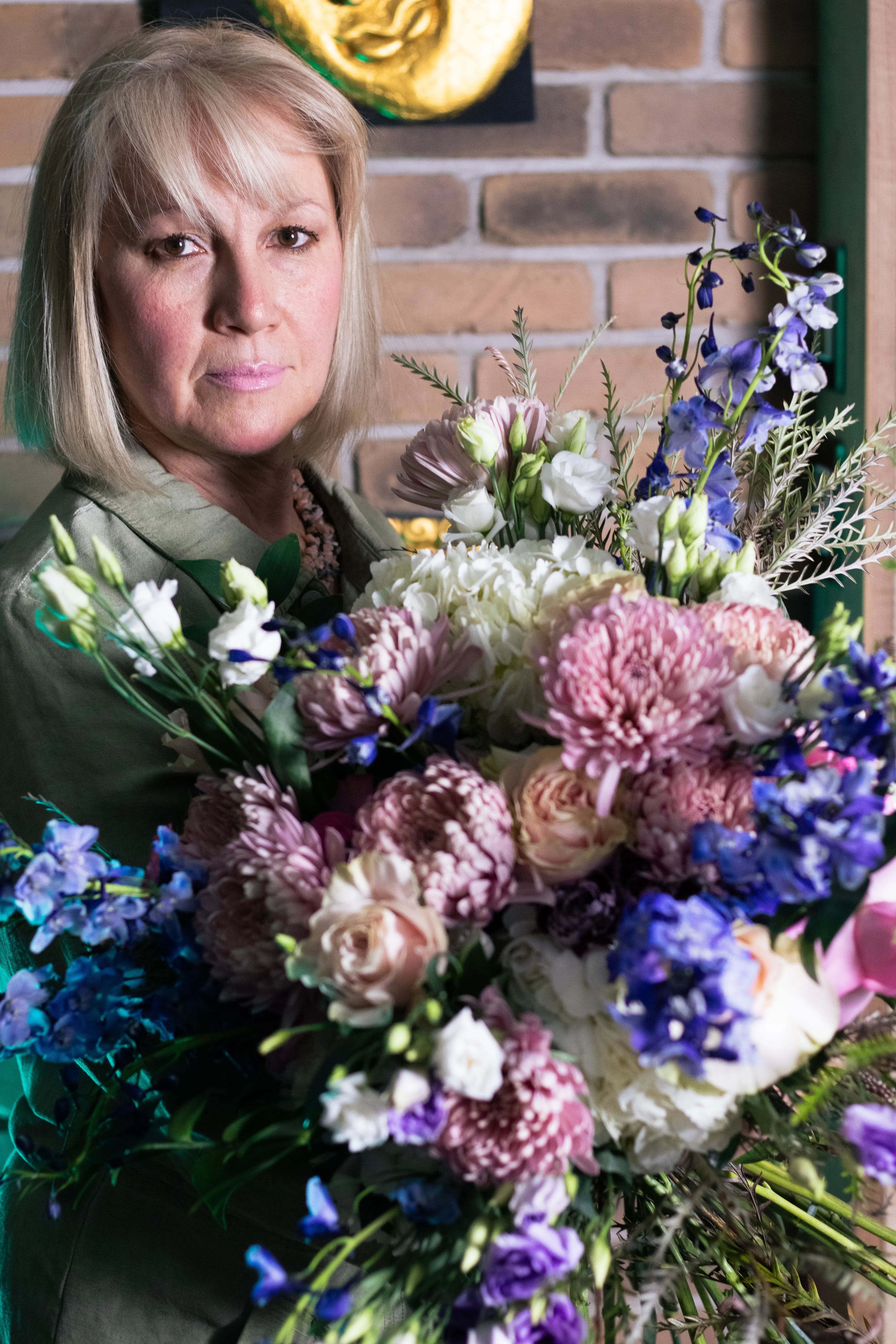 Elvira, Montreal wedding florist and founder, holding a handcrafted floral arrangement
