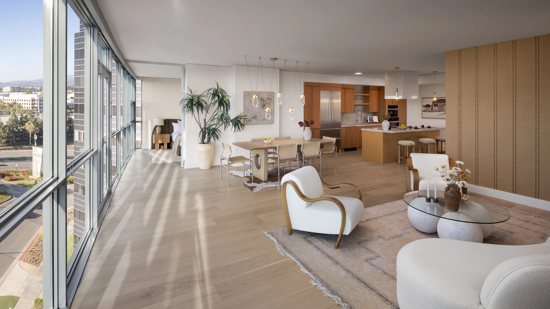 Skyline OC open-plan residence showing great room, kitchen, and wall of windows with panoramic Orange County views
