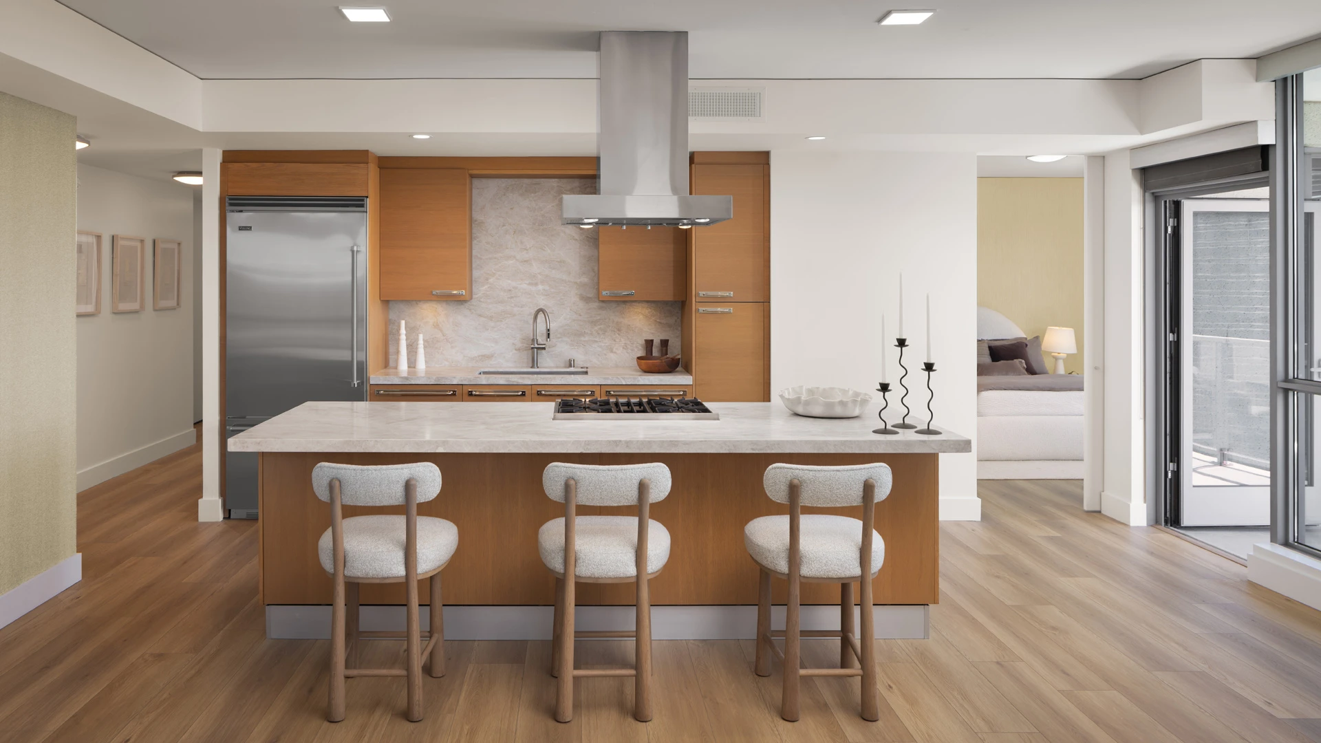 Skyline OC one-bedroom residence kitchen with stone island, premium appliances, and city views