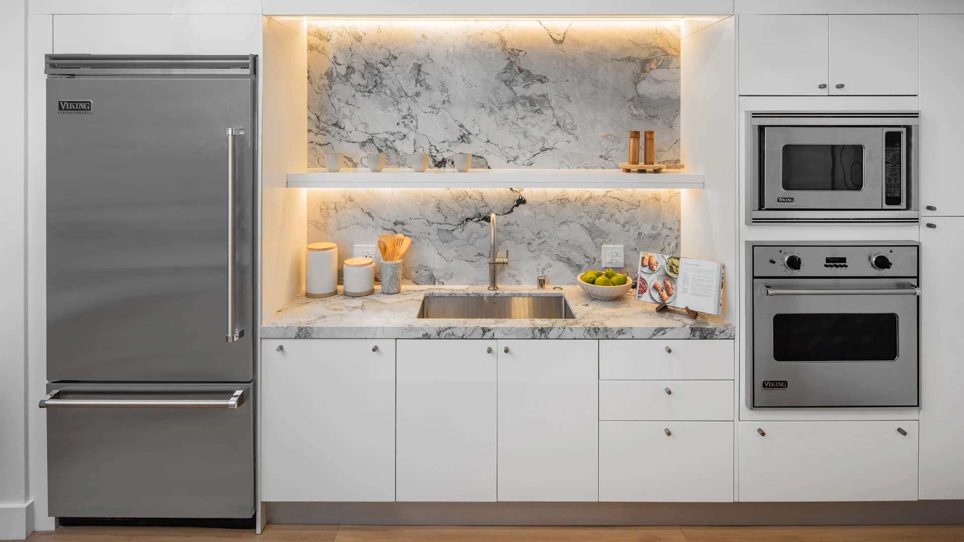 Premium Viking appliance wall with stainless steel refrigerator and oven stack in Skyline OC kitchen
