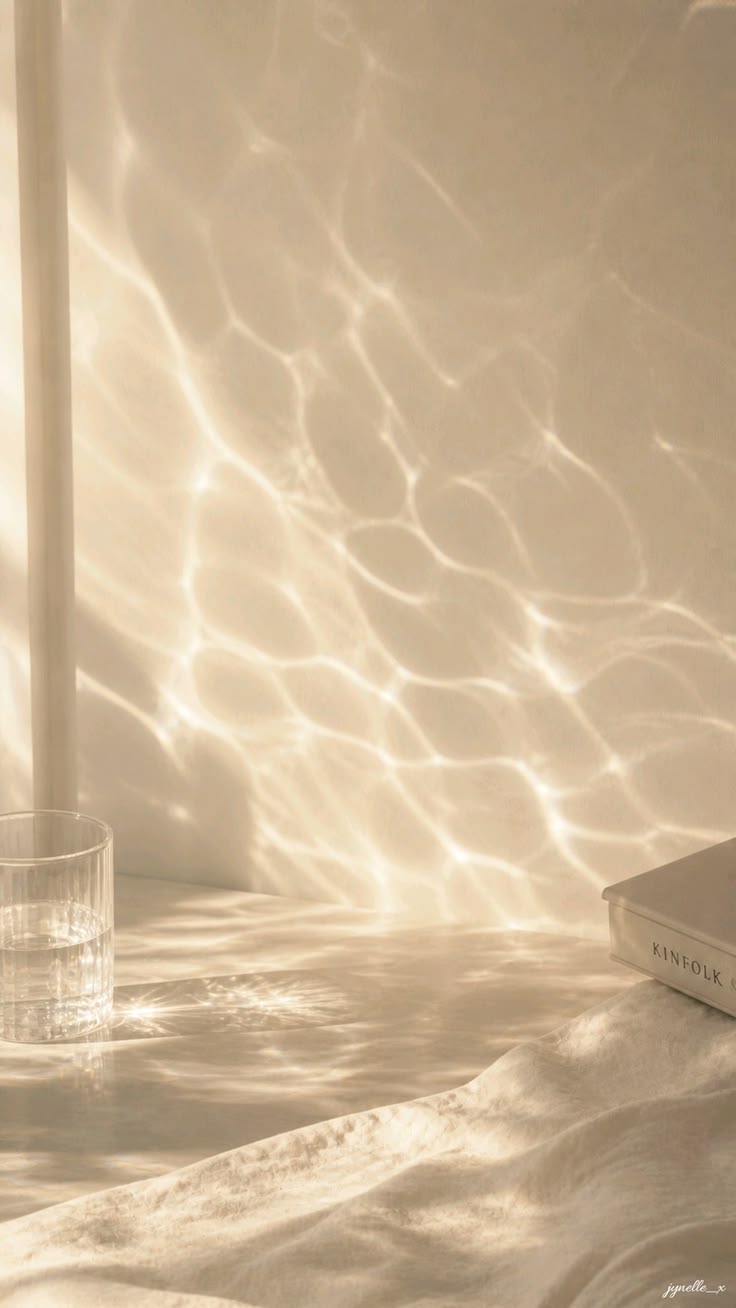 A glass of water resting on a calm water surface