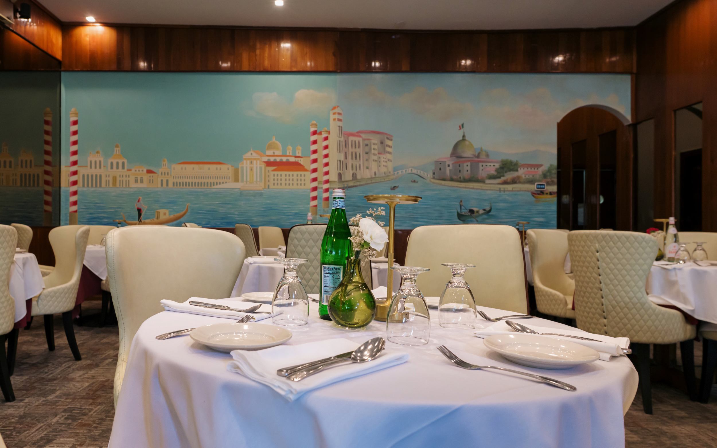 Set table in front of Italian coastal mural at Portofino