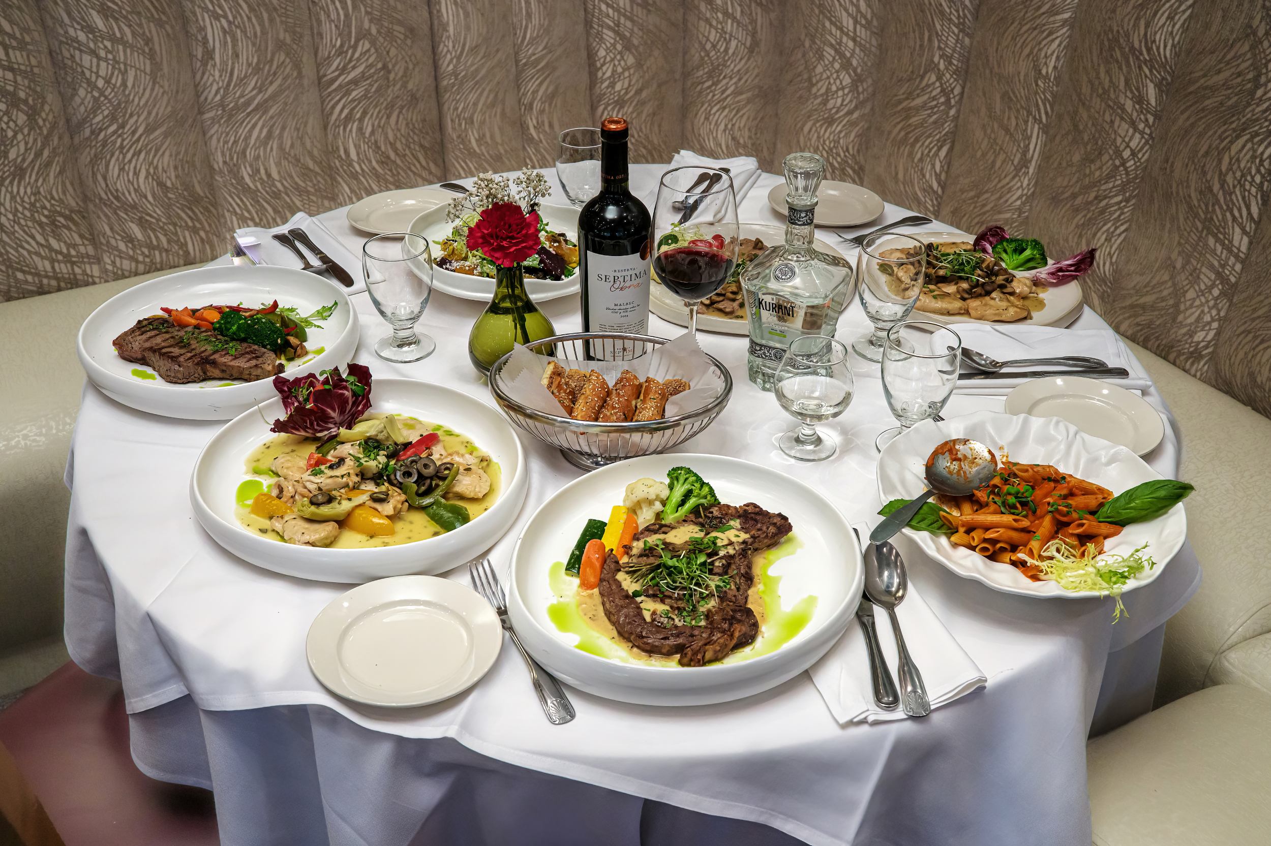 Set table with wine at Portofino Ristorante Forest Hills ready for online order pickup