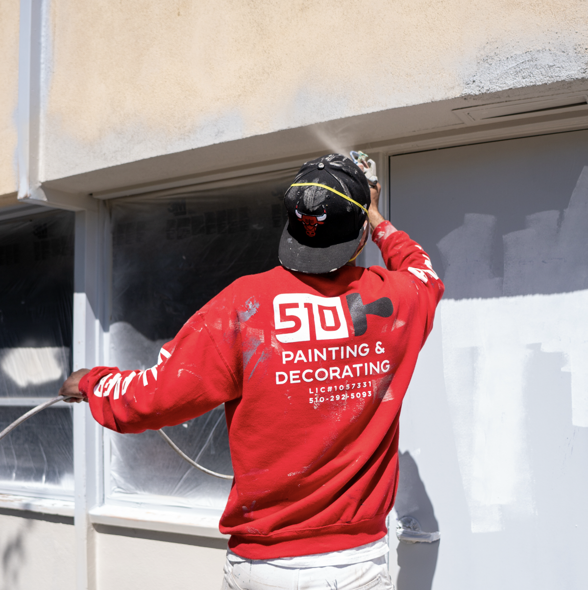 “Living room wall covered with textured grasscloth wallpaper installed by 510 Painting & Decorating – natural fiber finish and seamless application.”