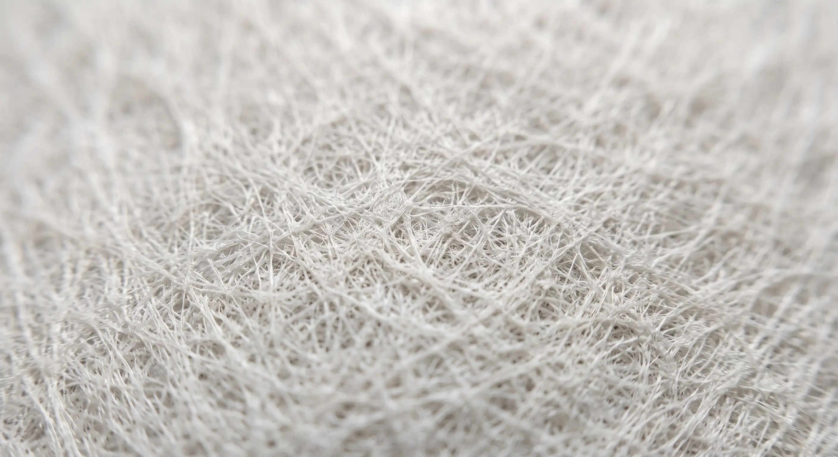 Close-up of non-woven house wrap showing the bonded fiber surface