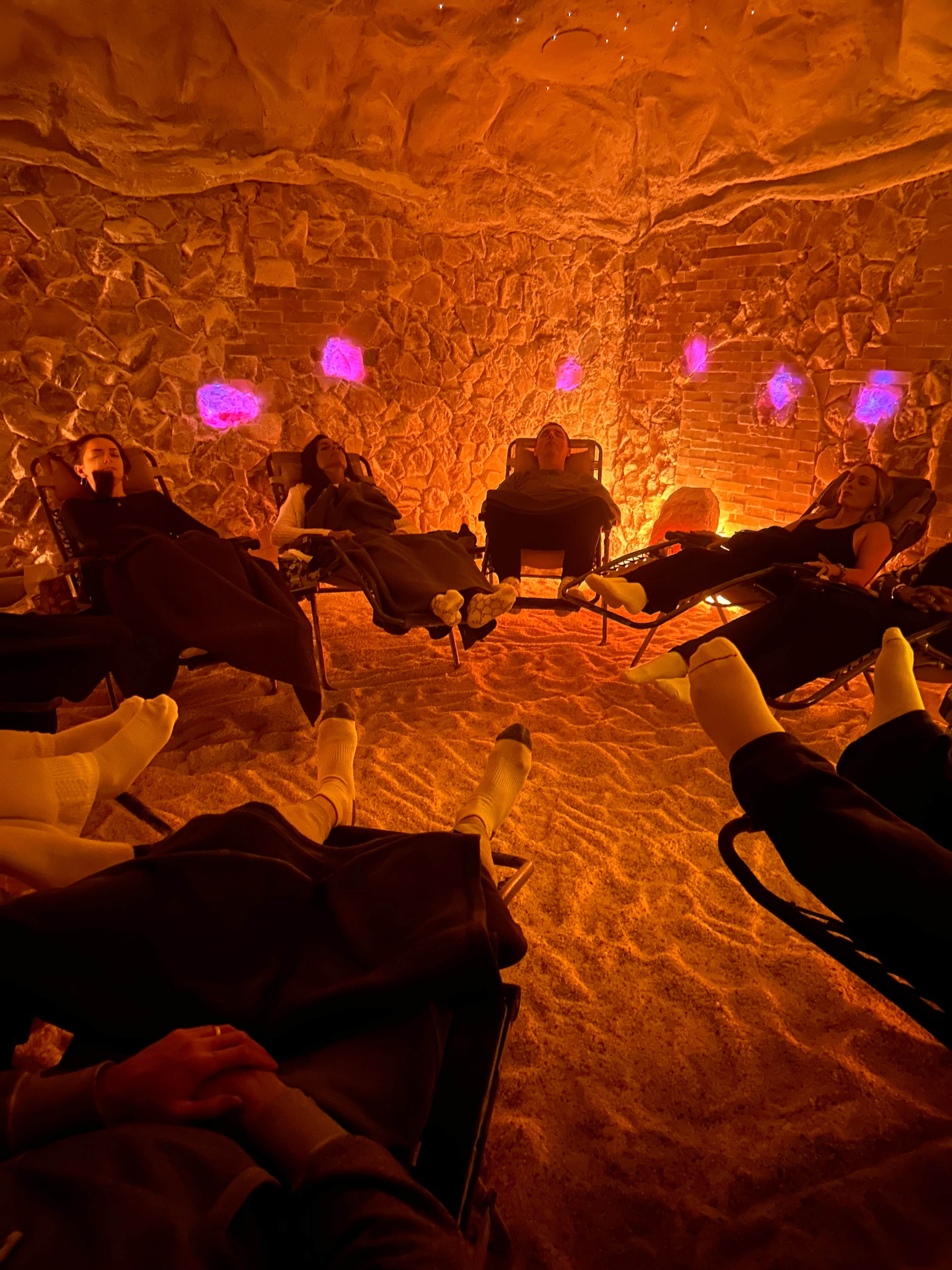 Guests relaxing together inside Tranquility Salt Cave