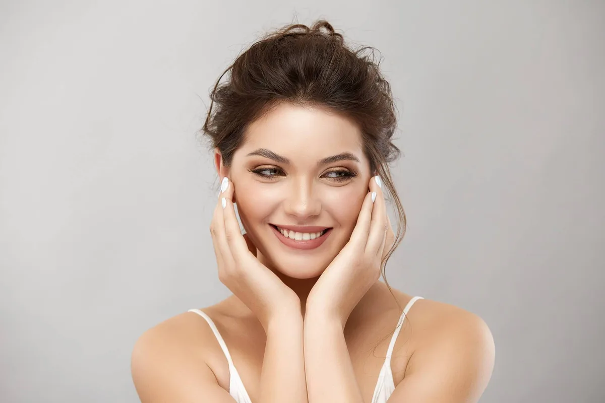 Woman smiling with clear, glowing skin