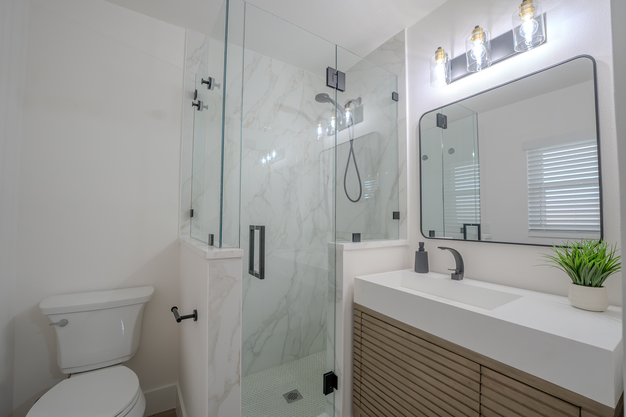 Bathroom remodel with custom double vanity and framed mirrors in Indian Rocks Beach FL