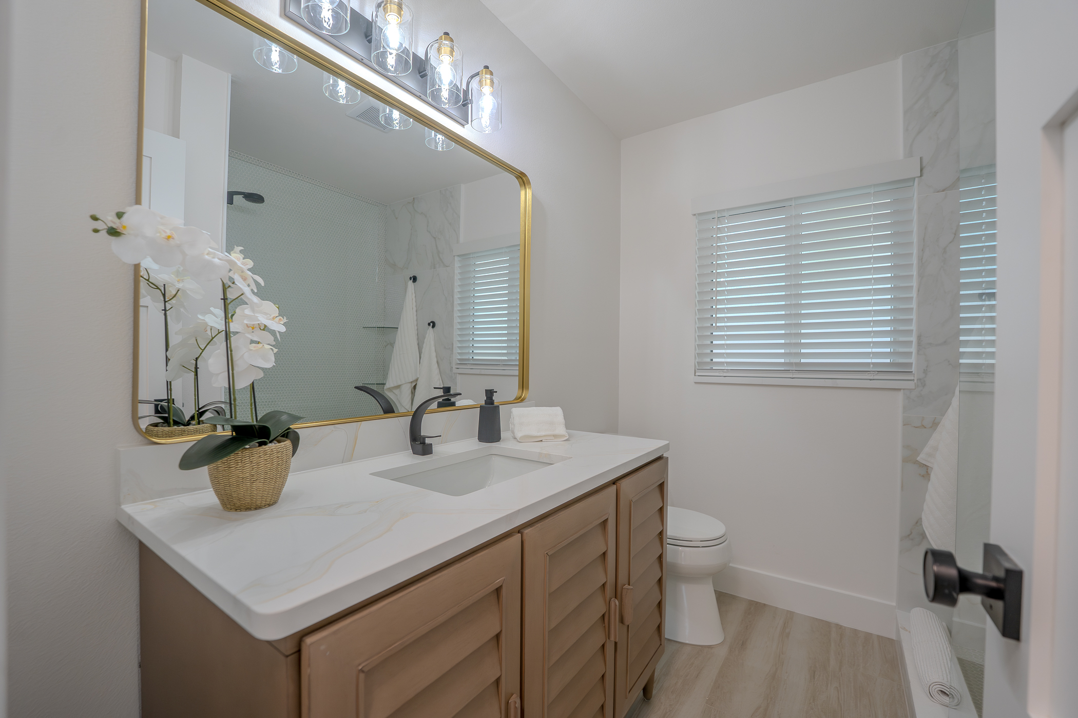 Custom bathroom vanity cabinetry with stone counter and fixtures in Belleair Bluffs FL